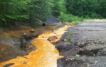 Acid mine drainage flowing through a stream in western Pennsylvania forest.